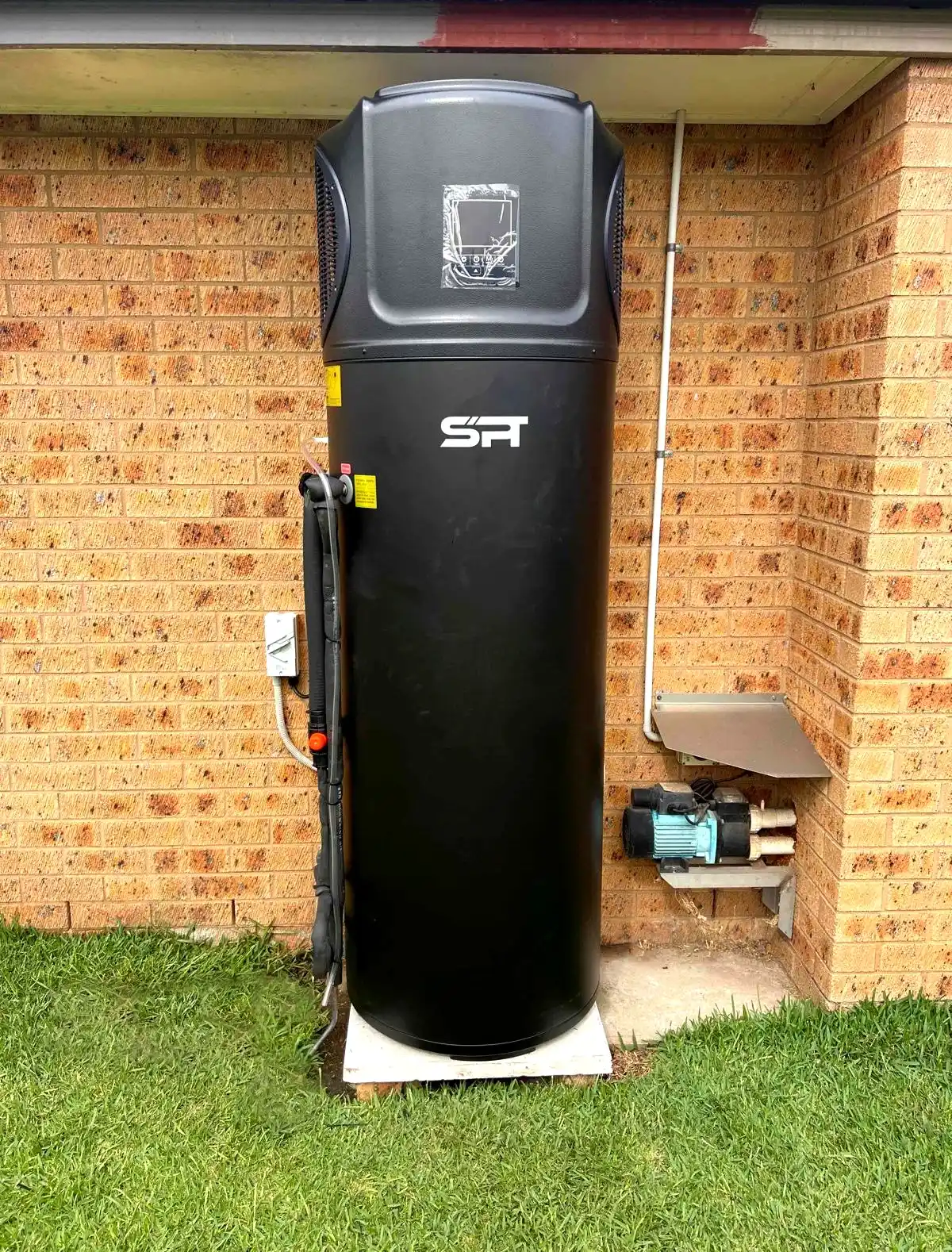 An SPT heat pump unit installed outside a residential property
